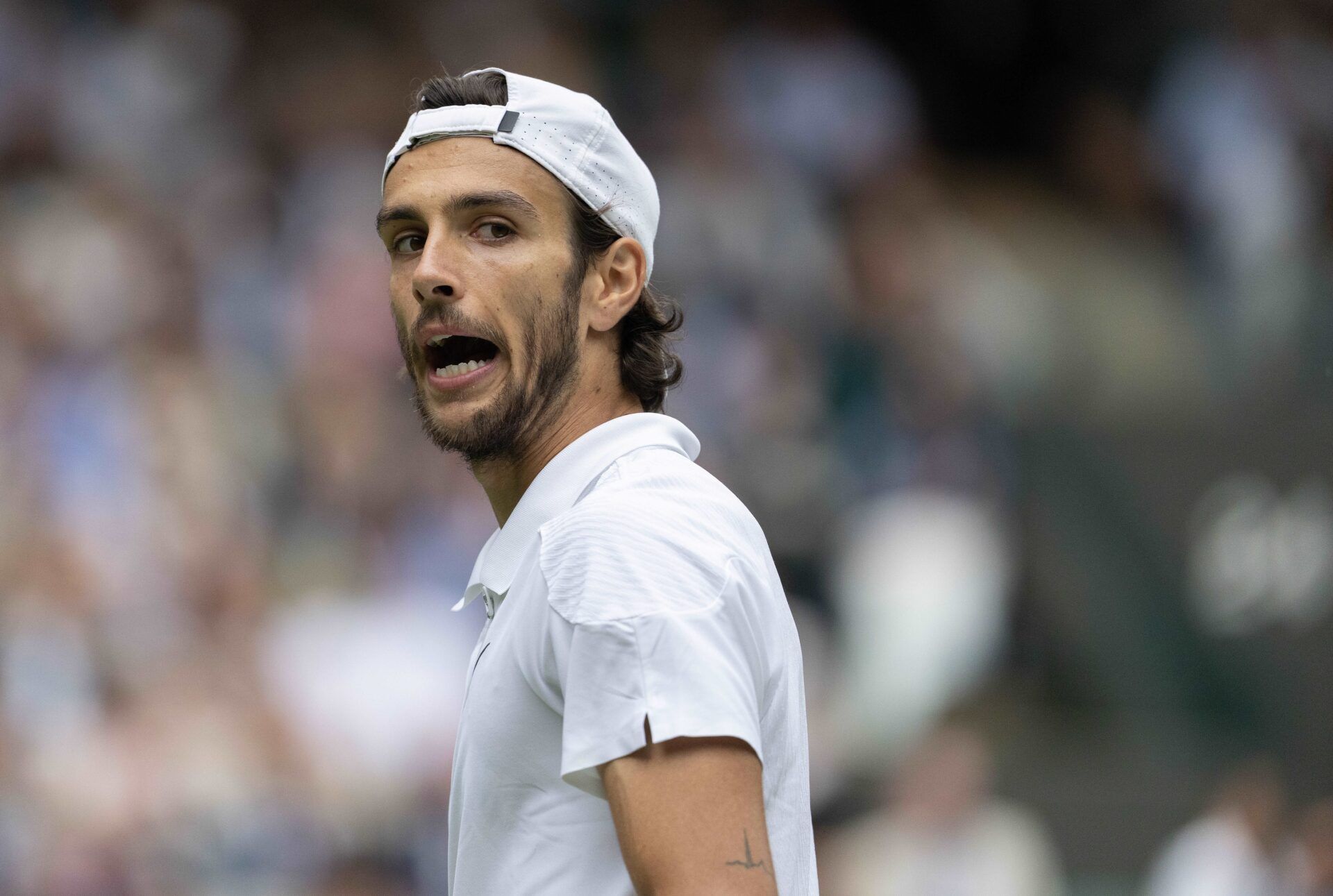 Lorenzo Musetti of Italy reacts to a point during his match against Taylor Fritz of the United States (not shown) on day 10 at All England Lawn Tennis and Croquet Club.