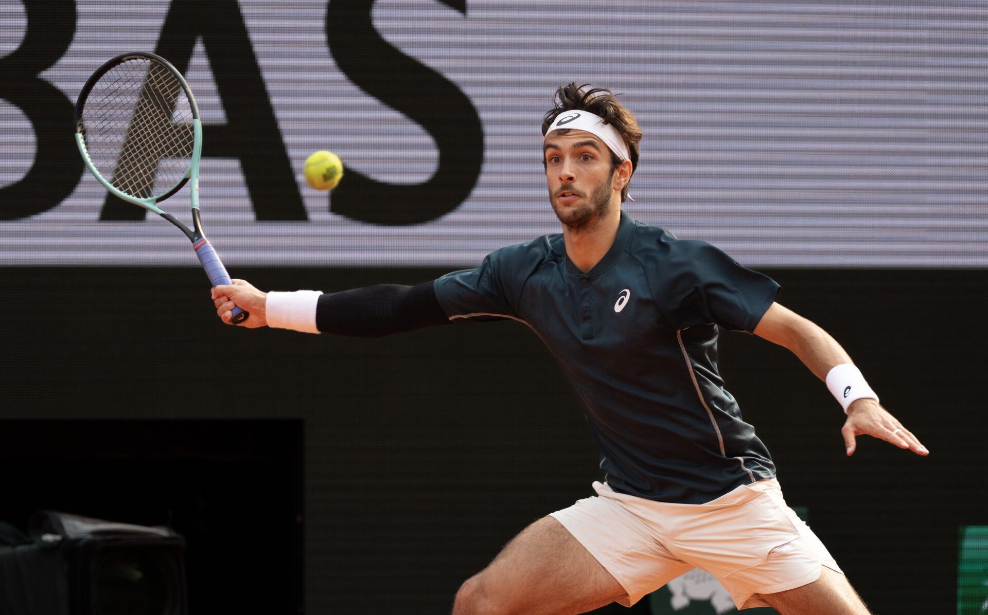 Lorenzo Musetti of Italy returns a shot during his match  against Frances Tiafoe of the United States on day 10 at Roland Garros Stadium.