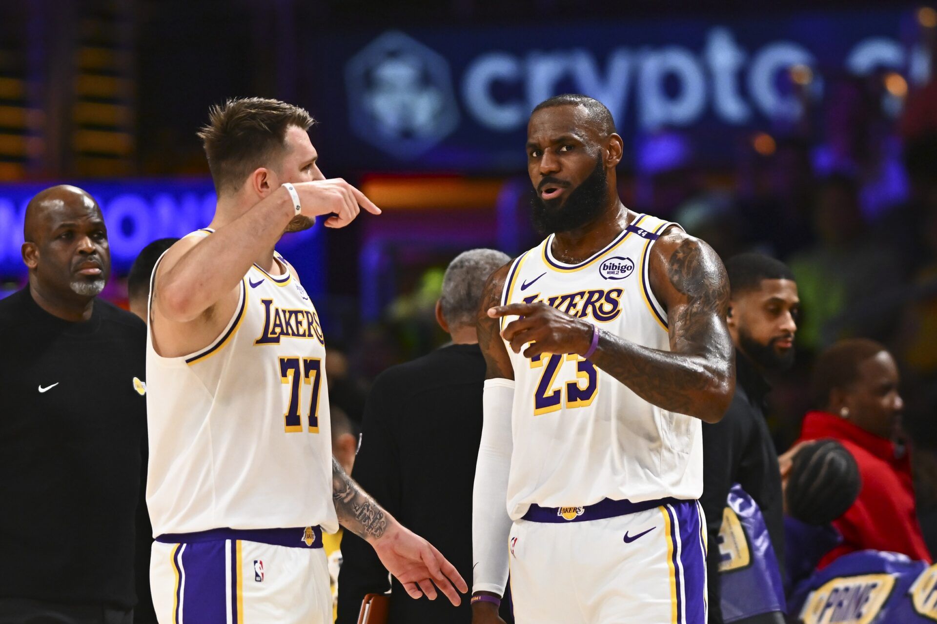 Los Angeles Lakers guard Luka Doncic (77) and Los Angeles Lakers forward LeBron James (23) on the sidelines against the Chicago Bulls during the first half at Crypto.com Arena.