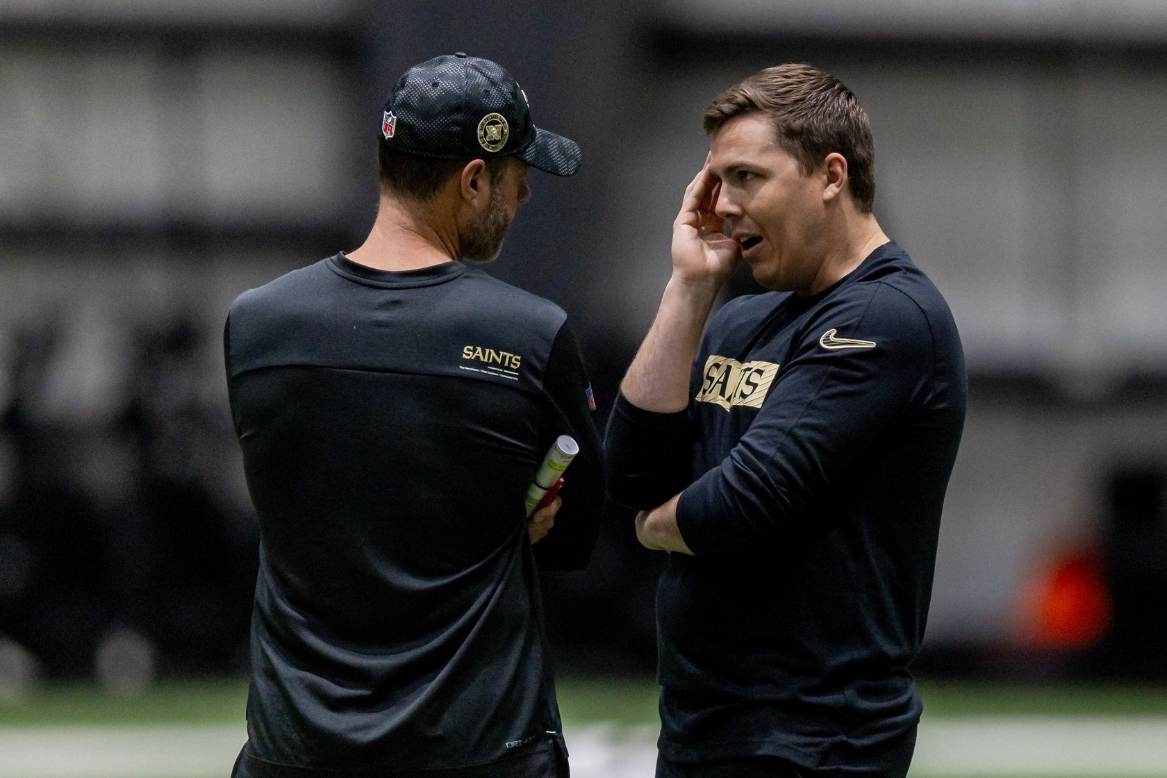 New Orleans Saints head coach Kellen Moore talks with defensive coordinator Brandon Staley during rookie minicamp at Ochsner Sports Performance Center.