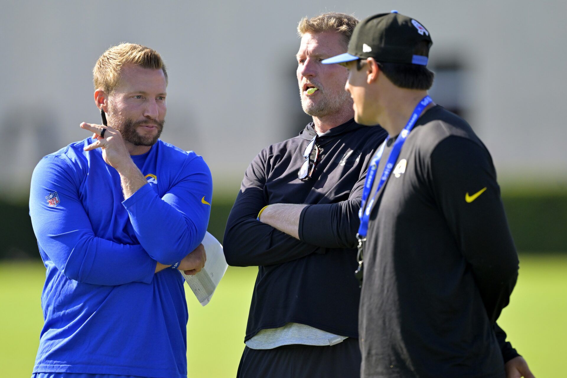 Los Angeles Rams head coach Sean McVay, general manager Les Snead and chief of staff Carter Crutchfield talk on the field during training camp at Loyola Marymount University.