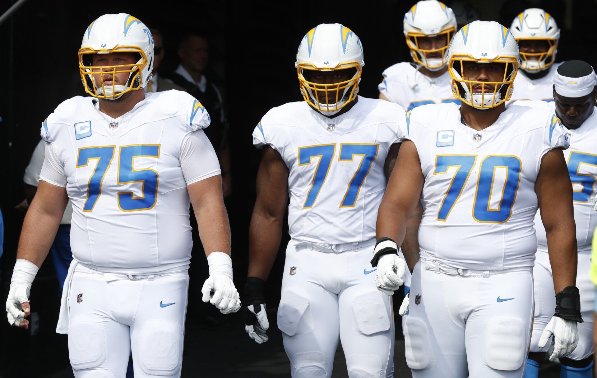 Los Angeles Chargers center Bradley Bozeman (75) and guard Zion Johnson (77) and offensive tackle Rashawn Slater (70) take the field against the Pittsburgh Steelers at Acrisure Stadium.