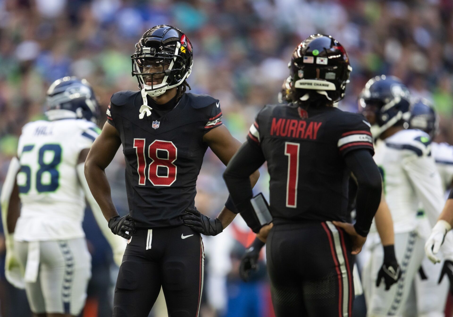 Arizona Cardinals wide receiver Marvin Harrison Jr. (18) alongside quarterback Kyler Murray (1) against the Seattle Seahawks in the first half at State Farm Stadium.