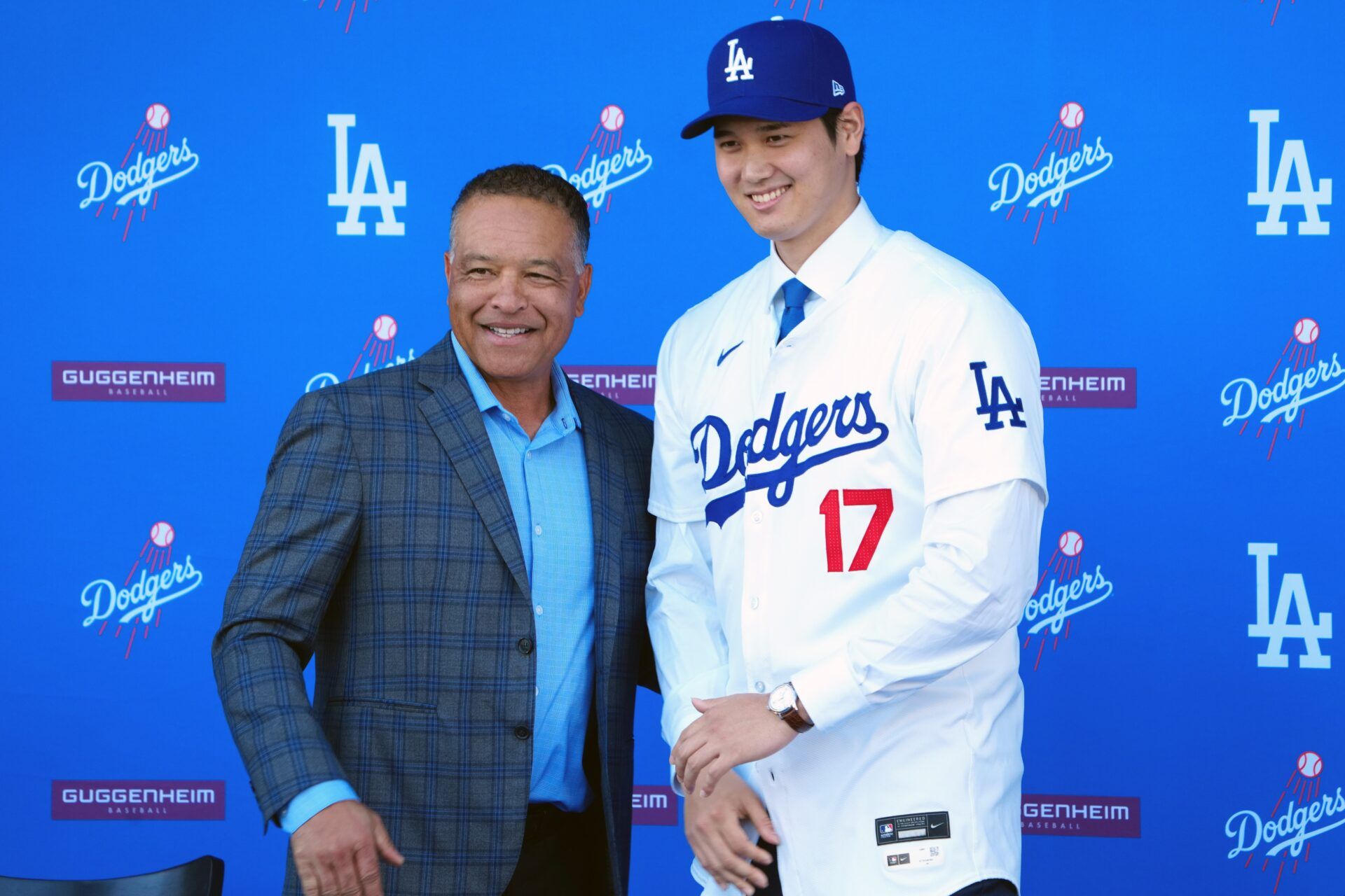 Los Angeles Dodgers designated hitter Shohei Ohtani (17) poses with manager Dave Roberts at Ohtani's introductory press conference at Dodger Stadium.