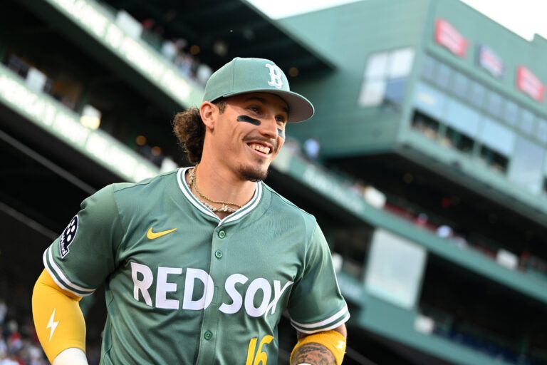 Boston Red Sox left fielder Jarren Duran (16) runs out of the dugout before the start of a game against the Atlanta Braves at Fenway Park.