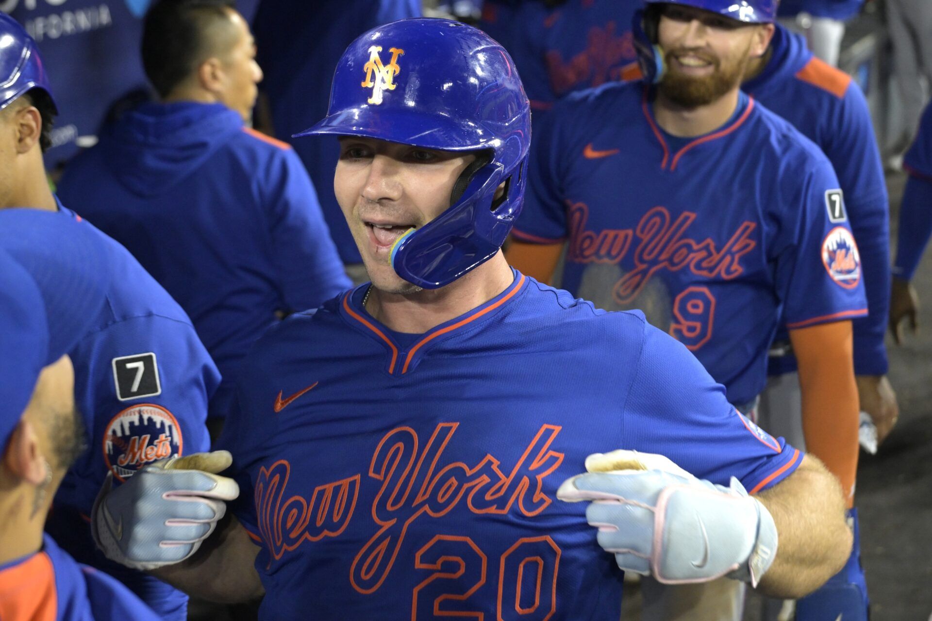 New York Mets first baseman Pete Alonso (20) is congratulated in the dugout after a three run home run in the eighth inning against the Los Angeles Dodgers at Dodger Stadium.