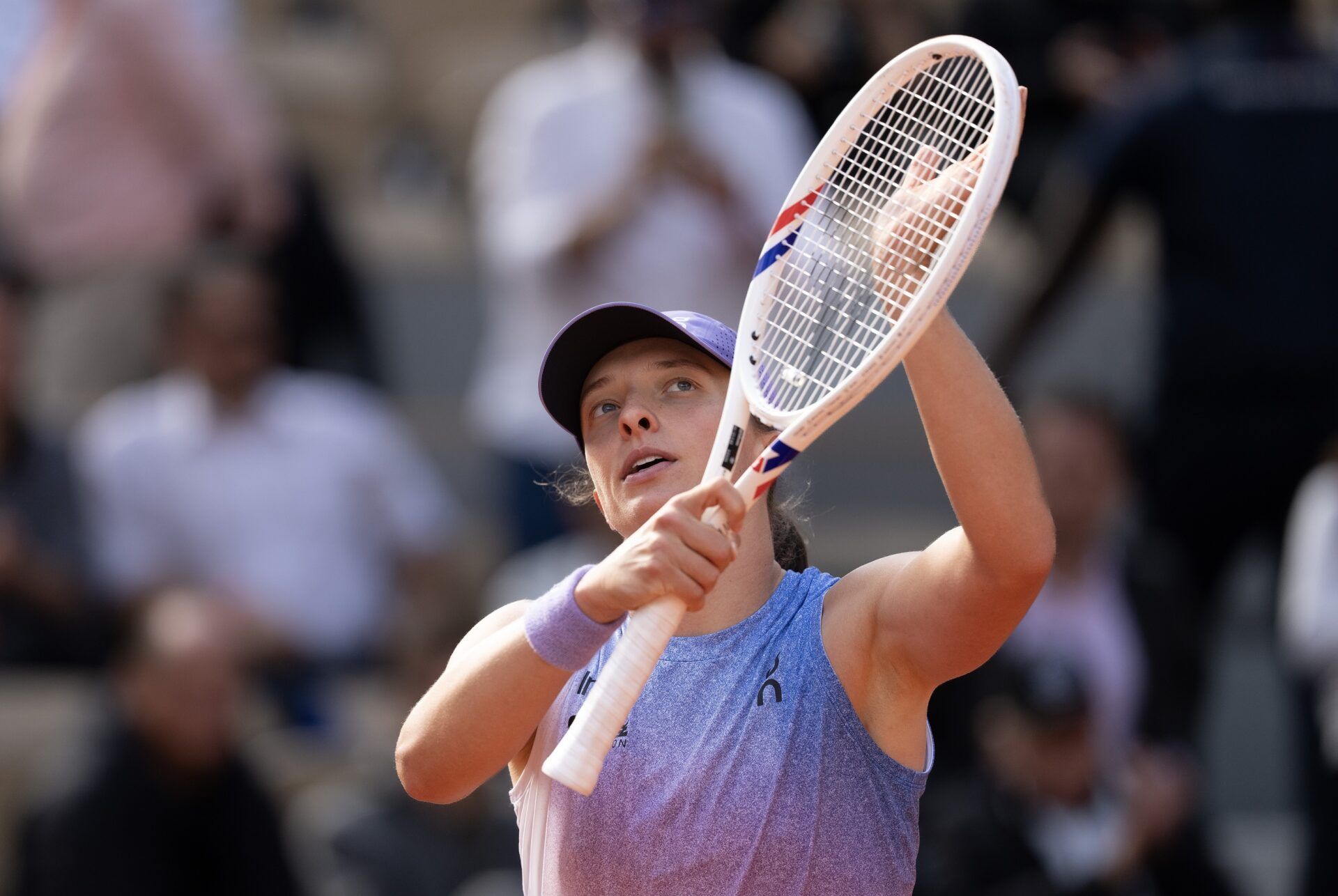 Iga Swiatek of Poland celebrates winning her match against Emma Raducanu of Great Britain on day four at Roland Garros Stadium.