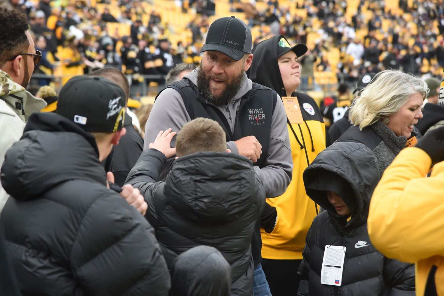 Retired Pittsburgh Steelers quarterback Ben Roethlisberger, center, jokes around on the sidelines before a game against the New Orleans Saints at Acrisure Stadium.