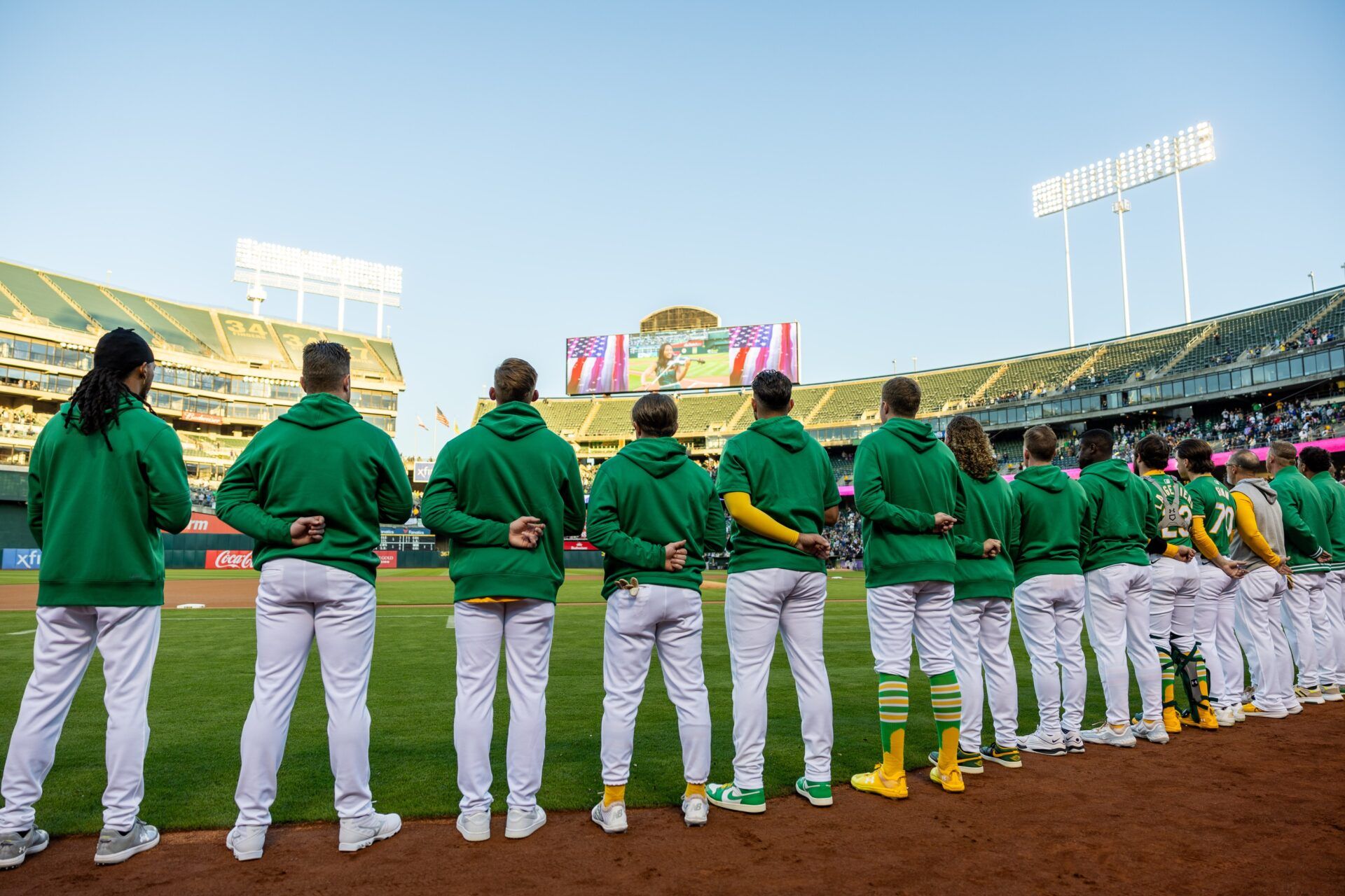 Oakland A’s players stand for the National Anthem before a game against the New York Yankees at Oakland-Alameda County Coliseum.