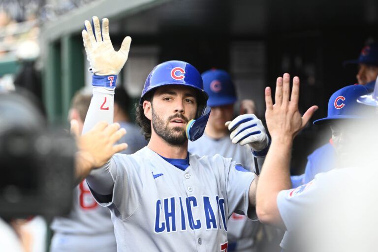 Chicago Cubs shortstop Dansby Swanson (7) is congratulated by teammates after hitting a RBI sacrifice fly against the Washington Nationals during the second inning at Nationals Park.
