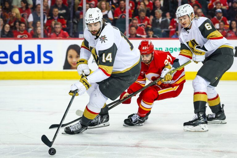 Vegas Golden Knights defenseman Nicolas Hague (14) controls the puck against the Calgary Flames during the second period at Scotiabank Saddledome.