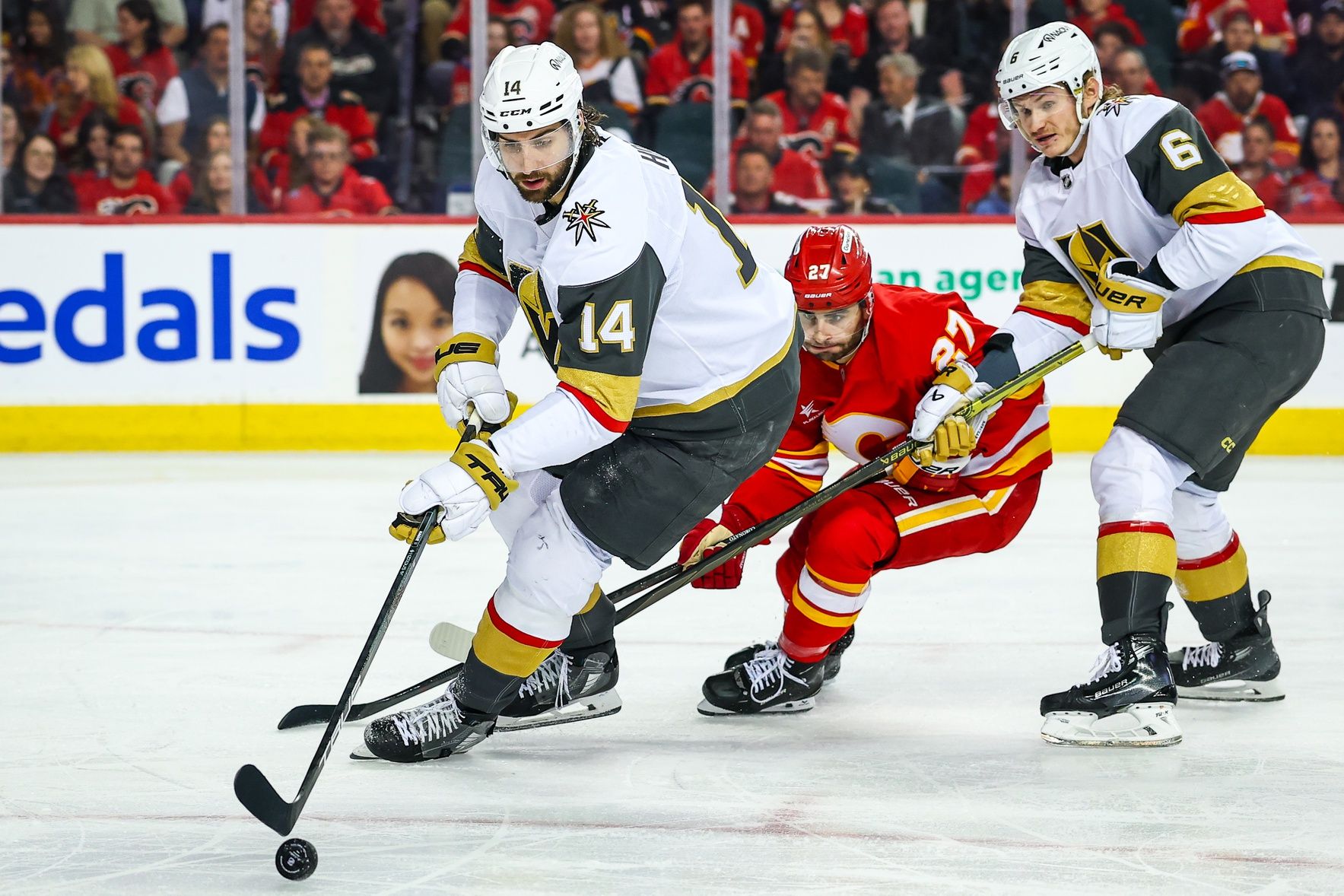 Vegas Golden Knights defenseman Nicolas Hague (14) controls the puck against the Calgary Flames during the second period at Scotiabank Saddledome.