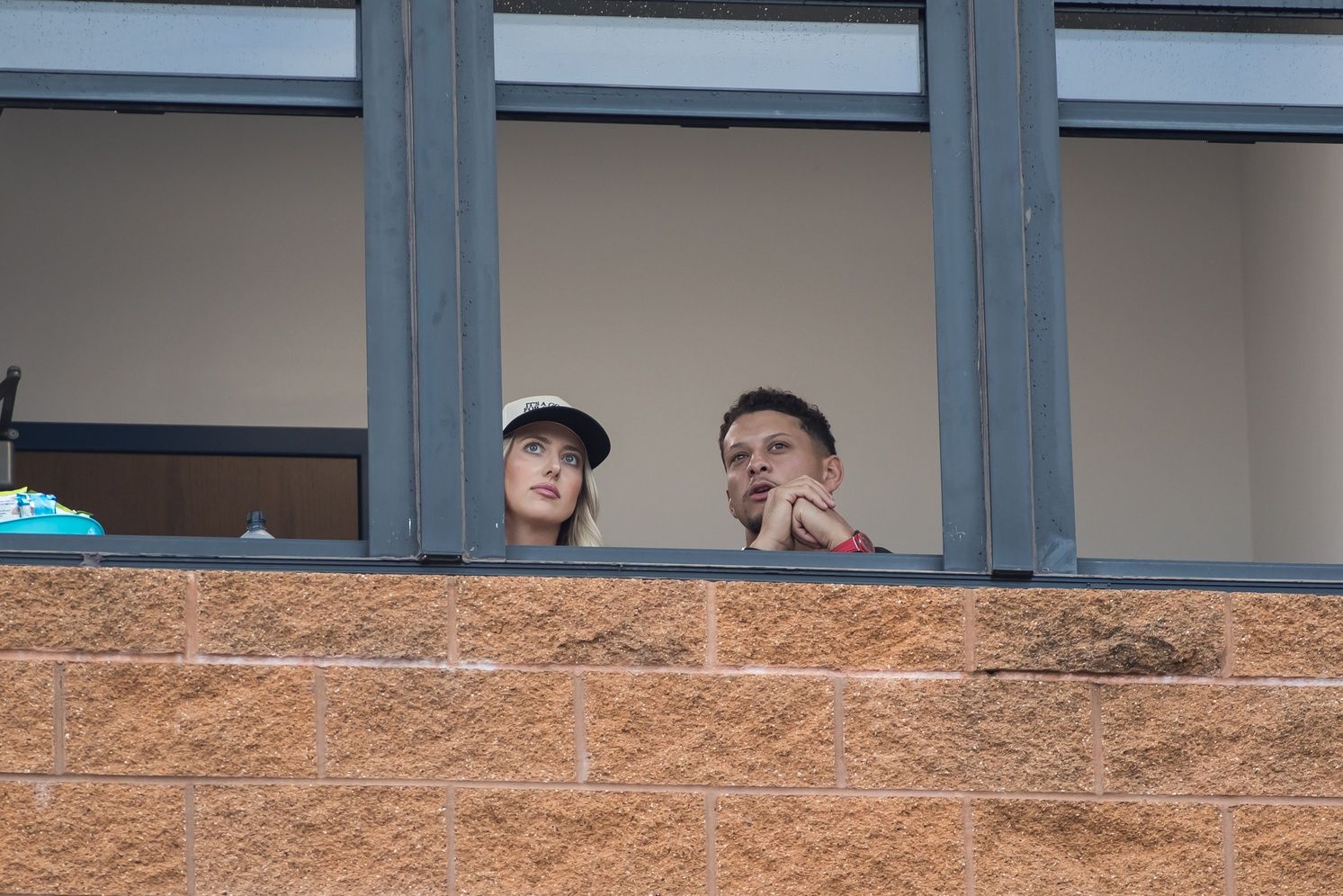 Patrick Mahomes and his wife Brittany Mahomes watch the Texas Longhorns and Texas Tech Red Raiders during game two of the NCAA Softball Women's College World Series finals at Devon Park.