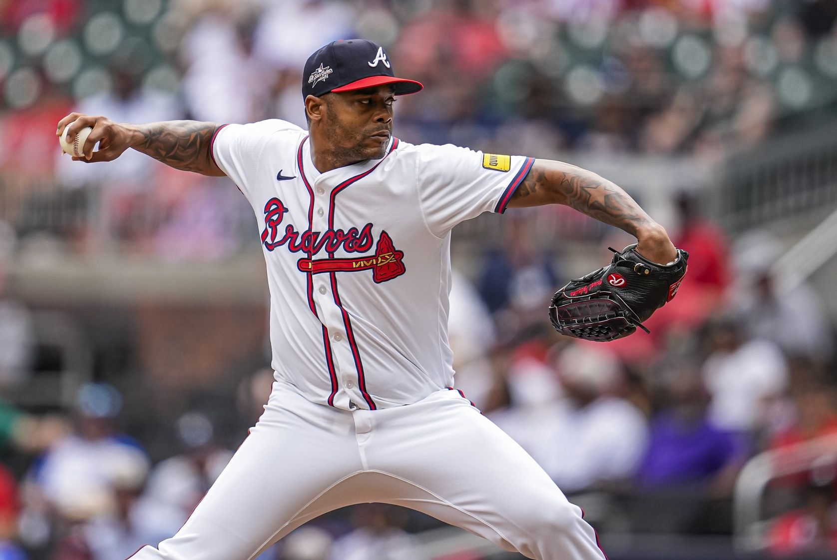 Atlanta Braves relief pitcher Raisel Iglesias (26) pitches against the Arizona Diamondbacks during the ninth inning at Truist Park.