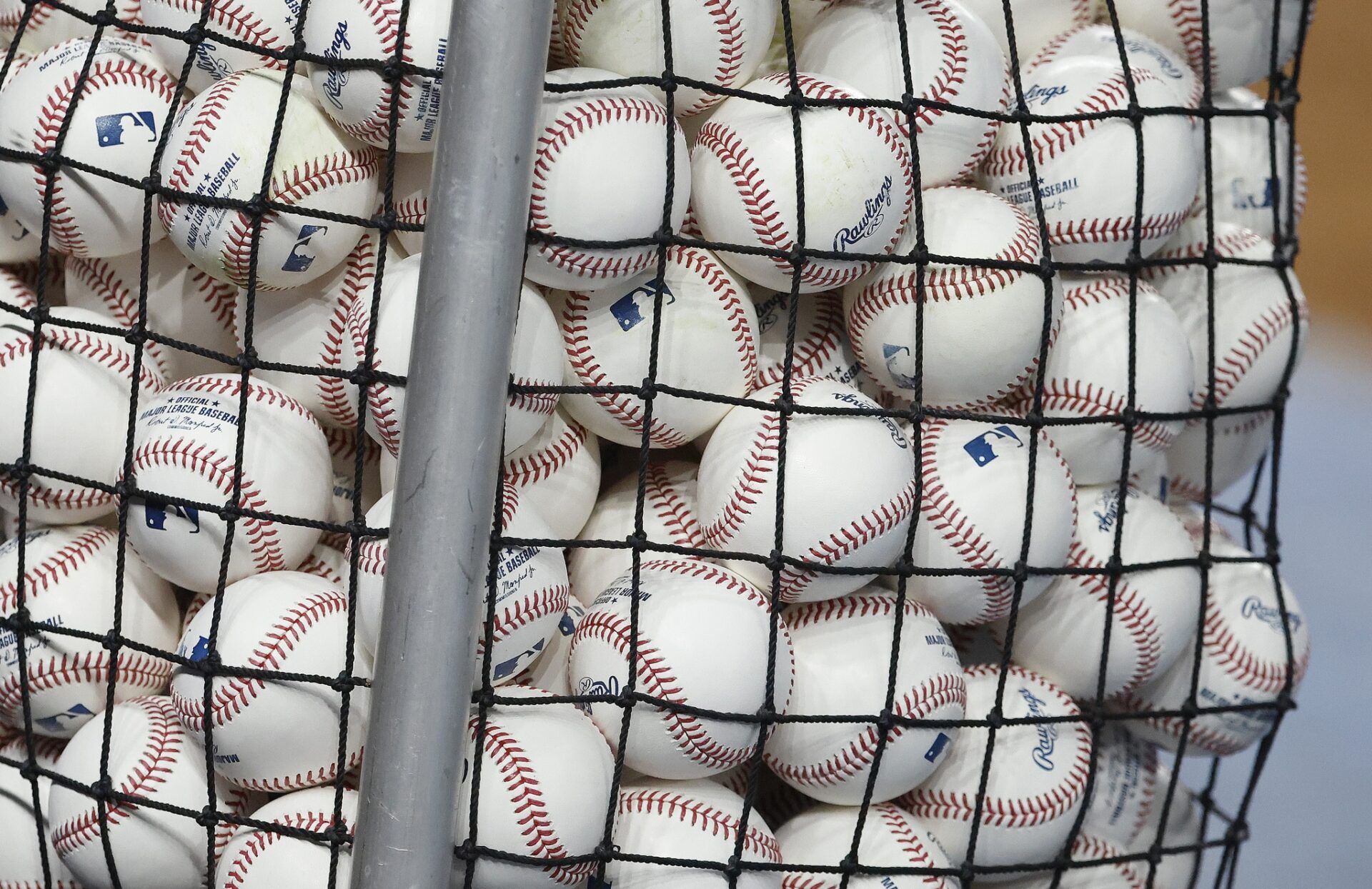 A bucket of baseball sits on the field before the game between the Colorado Rockies and the Miami Marlins before the game at loanDepot Park.