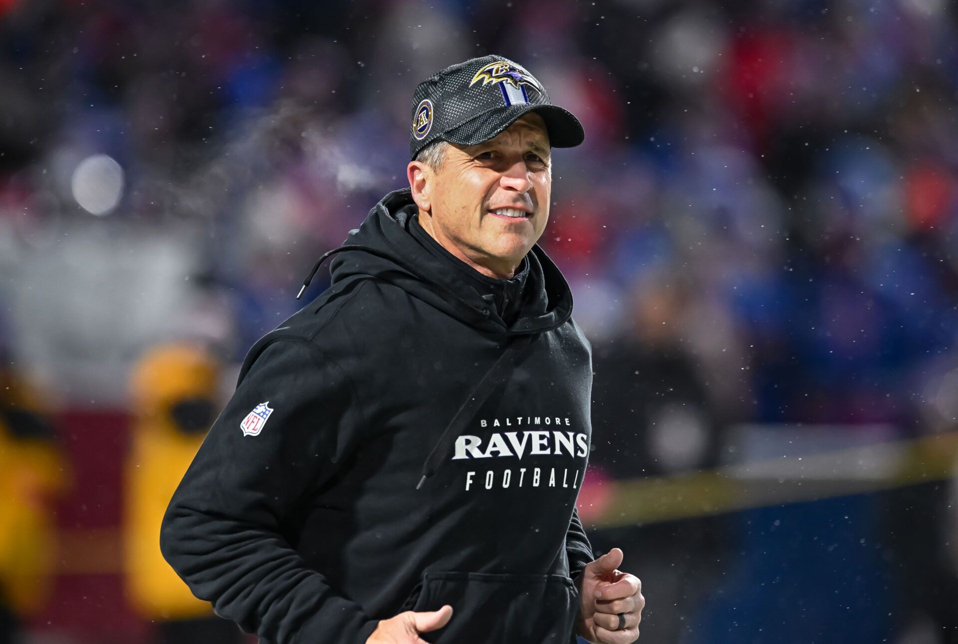 Baltimore Ravens head coach John Harbaugh enters the field before a 2025 AFC divisional round game against the Buffalo Bills at Highmark Stadium.
