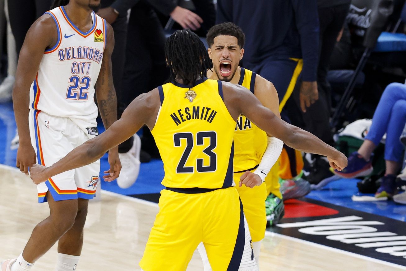 Indiana Pacers guard Tyrese Haliburton (0) and forward Aaron Nesmith (23) celebrate after Haliburton makes the game winning shot as Oklahoma City Thunder guard Cason Wallace (22) looks on during the fourth quarter during game one of the 2025 NBA Finals at Paycom Center.