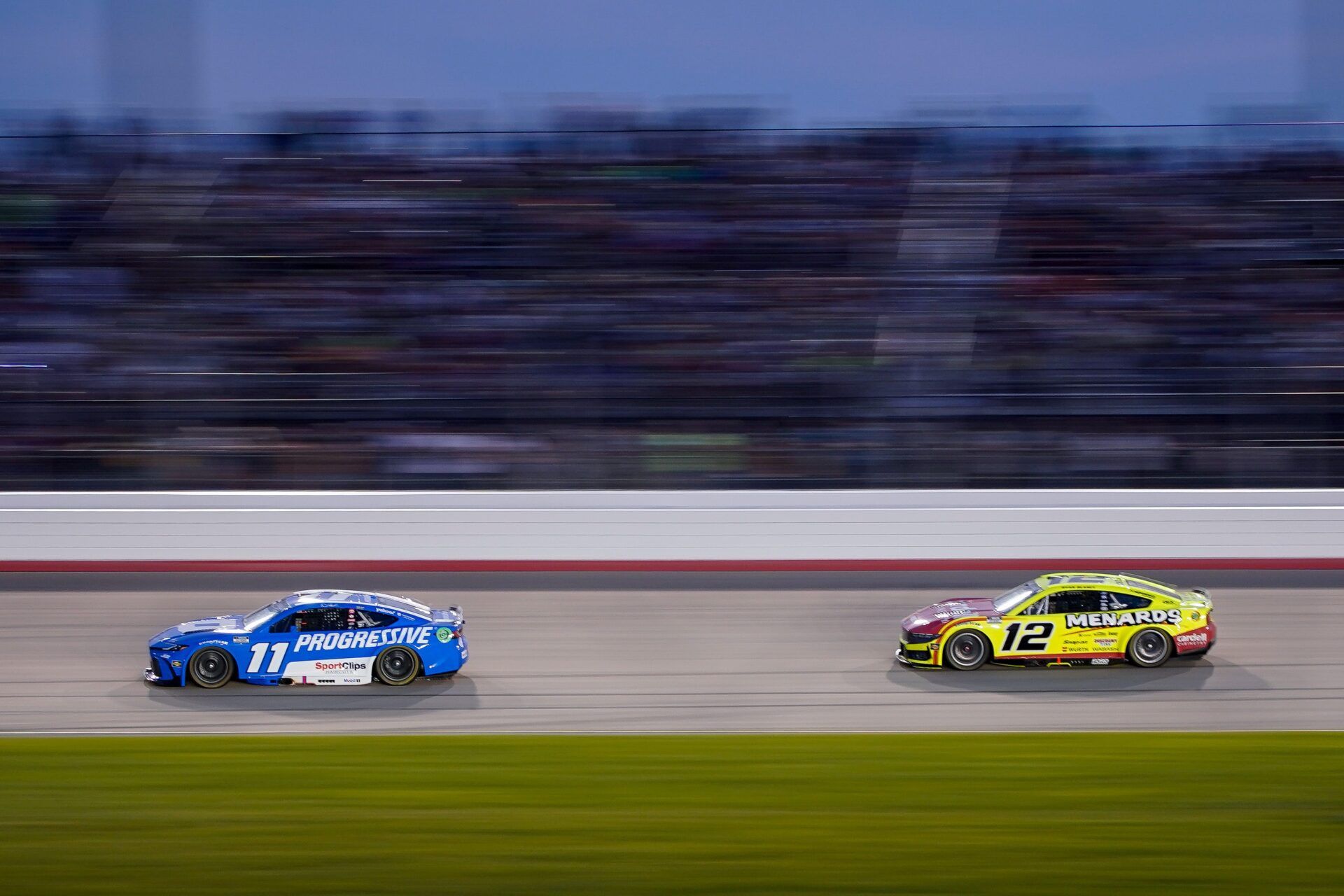 NASCAR Cup Series driver Denny Hamlin (11) battles Ryan Blaney (12) during the Cracker Barrel 400 at Nashville Superspeedway in Lebanon, Tenn., Sunday, June 1, 2025.