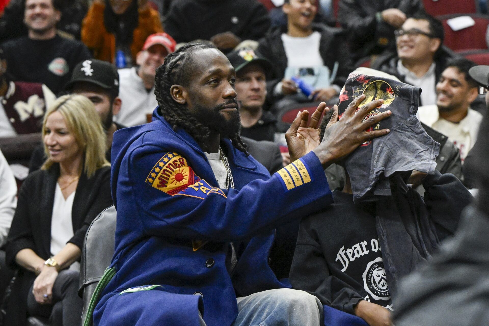Former Chicago Bulls player Pat Beverley, left, is seen with his son, Elijah Beverly, courtside during the second half of thegame between the Chicago Bulls and the LA Clippers at the United Center.