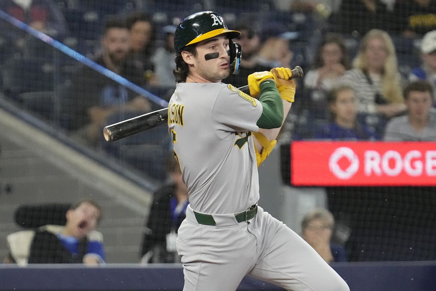 Oakland Athletics shortstop Jacob Wilson (5) hits a single against the Toronto Blue Jays during the first inning at Rogers Centre.