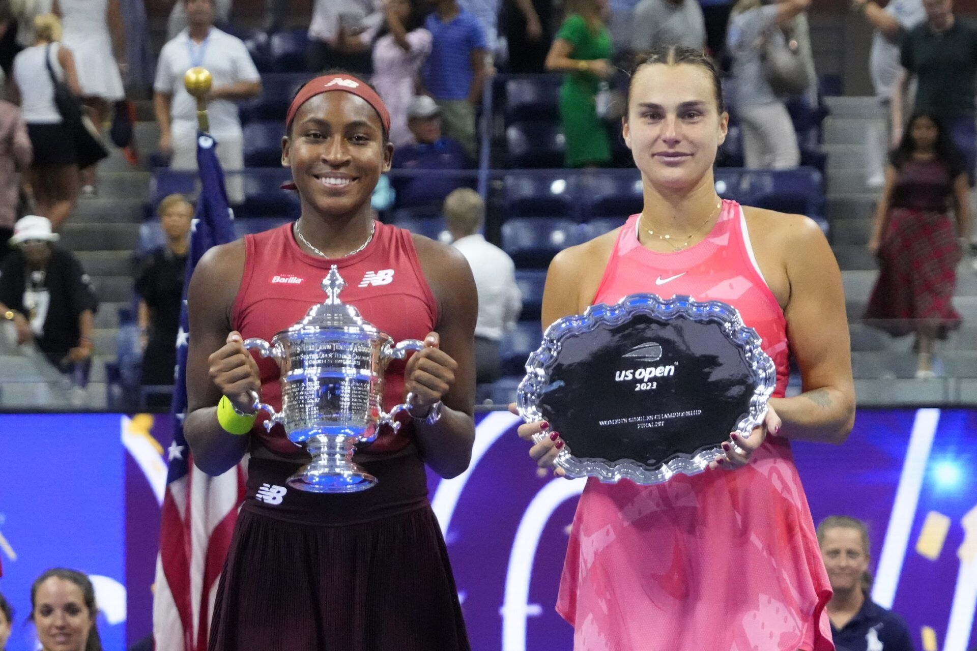 (L-R) Coco Gauff of the United States and Aryna Sabalenka celebrate with the championship and finalist trophies, respectively, after their match in the women's singles finalon day thirteen of the 2023 U.S. Open tennis tournament at USTA Billie Jean King Tennis Center.