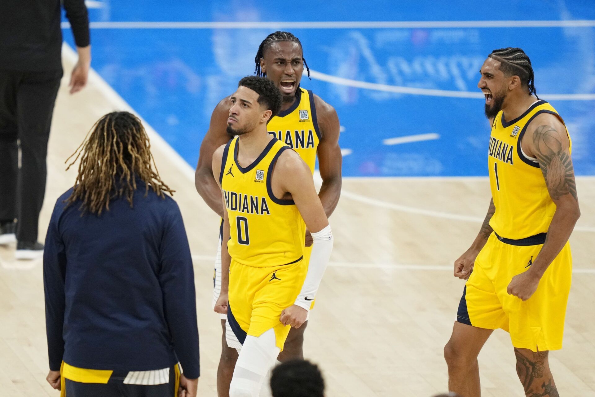 Indiana Pacers guard Tyrese Haliburton (0), forward Aaron Nesmith (center) and forward Obi Toppin (1) react after a play against the Oklahoma City Thunder in game one of the 2025 NBA Finals at Paycom Center.