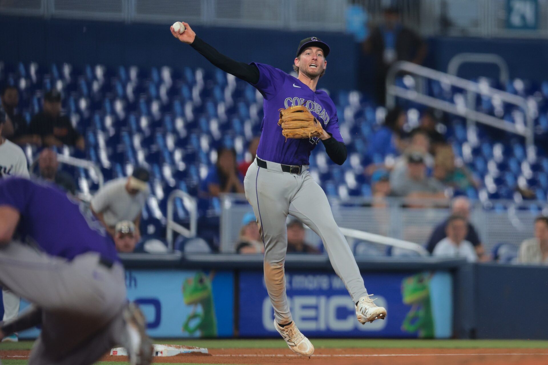 Colorado Rockies third baseman Ryan McMahon (24) throws to first base to retire Miami Marlins second baseman Jack Winkler (not pictured) during the sixth inning at loanDepot Park.