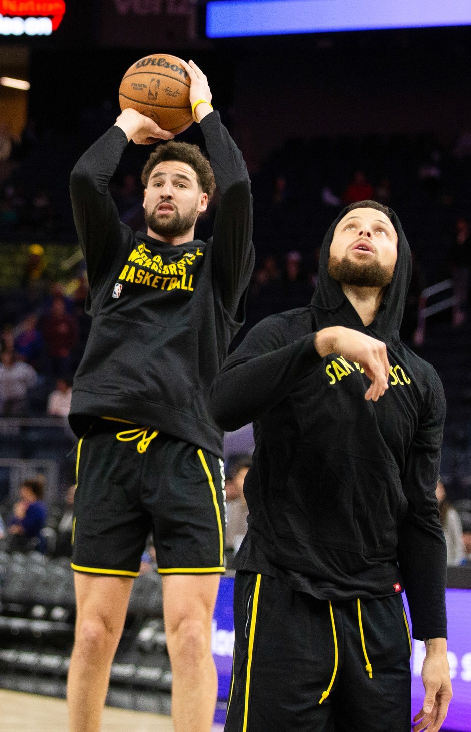 Golden State Warriors guards Klay Thompson (left) and Stephen Curry (right) warm up before taking on the Detroit Pistons at Chase Center.