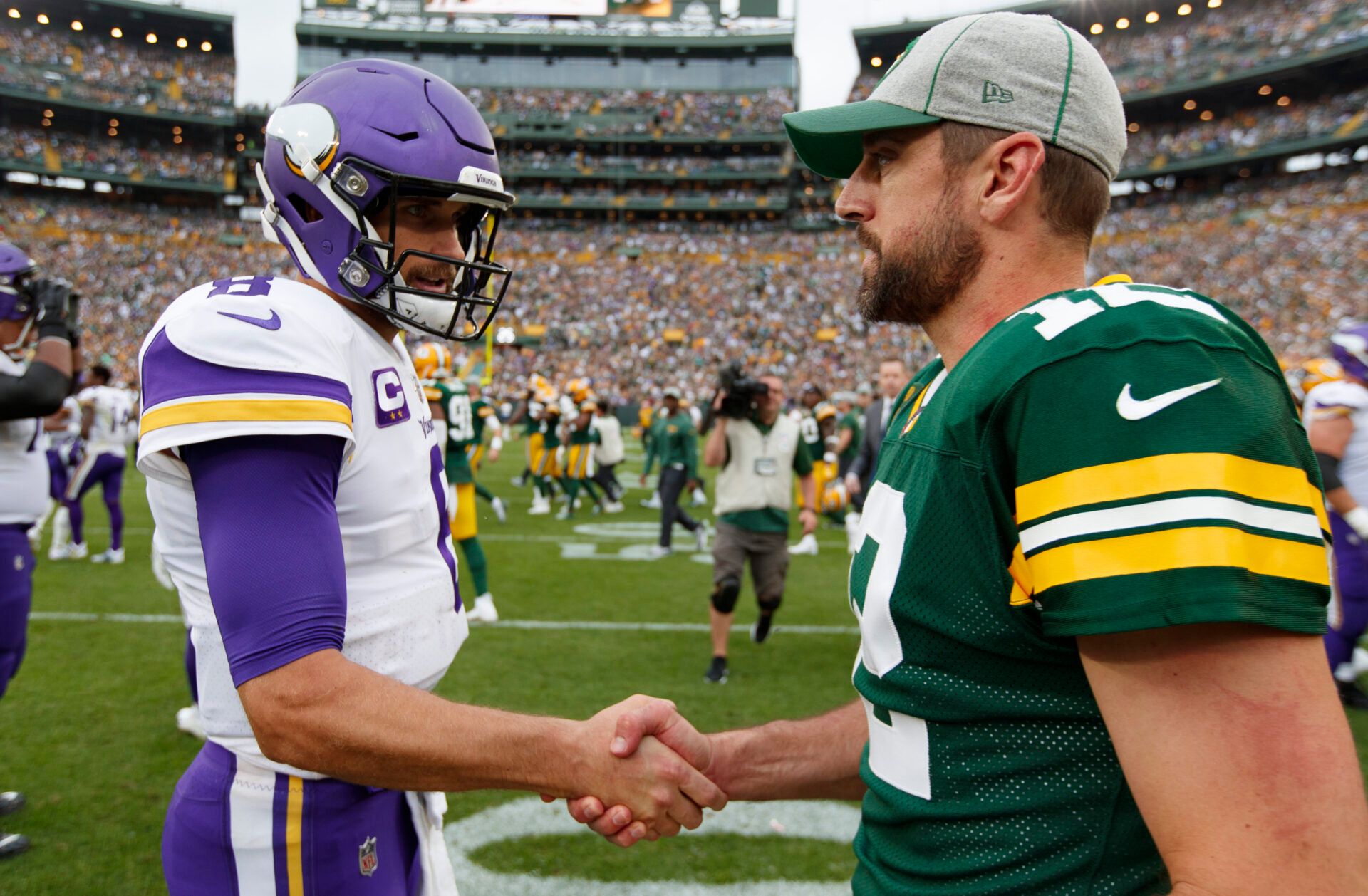 Minnesota Vikings quarterback Kirk Cousins (8) greets Green Bay Packers quarterback Aaron Rodgers (12) on the field following the game at Lambeau Field.