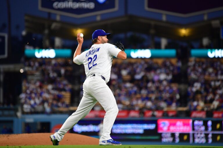 Los Angeles Dodgers pitcher Clayton Kershaw (22) makes a throw to first base against the New York Mets during the third inning at Dodger Stadium.