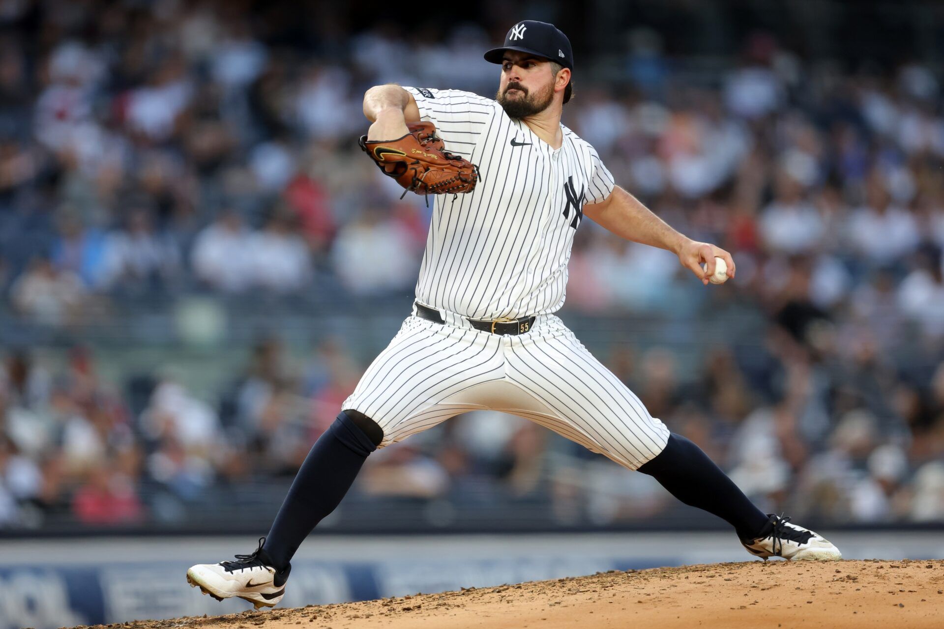 New York Yankees starting pitcher Carlos Rodon (55) pitches against the Cleveland Guardians during the third inning at Yankee Stadium.