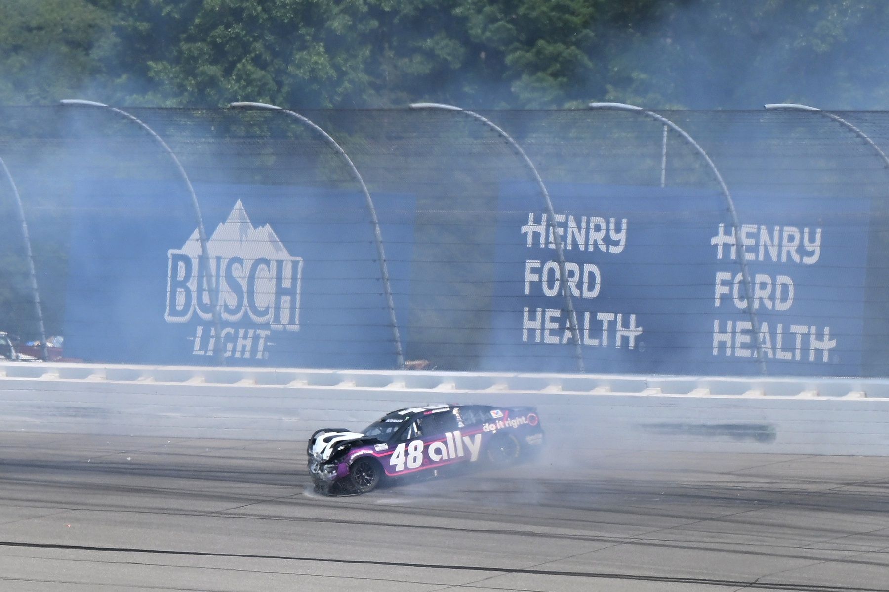 NASCAR Cup Series driver Alex Bowman (48) spins down the track after hitting the wall in turn two just after a restart in stage two of FireKeepers Casino 400 at Michigan International Speedway.