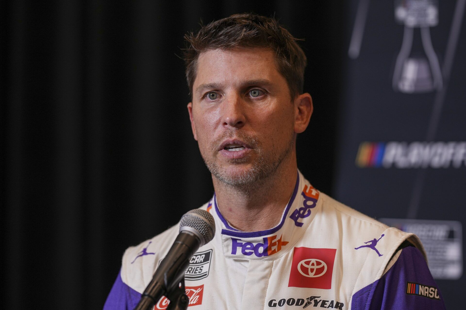 Denny Hamlin speaks to media members during the NASCAR Playoffs Media Day at the Charlotte Convention Center.