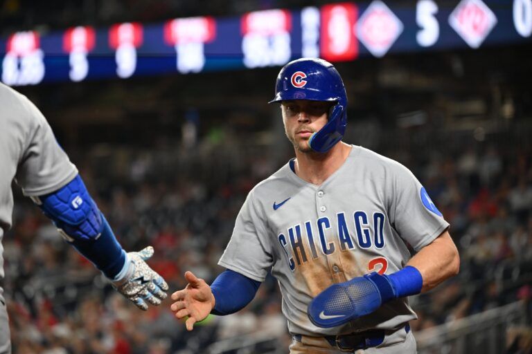 Chicago Cubs second baseman Nico Hoerner (2) walks back the to dugout after scoring a run during the ninth inning against the Washington Nationals at Nationals Park.