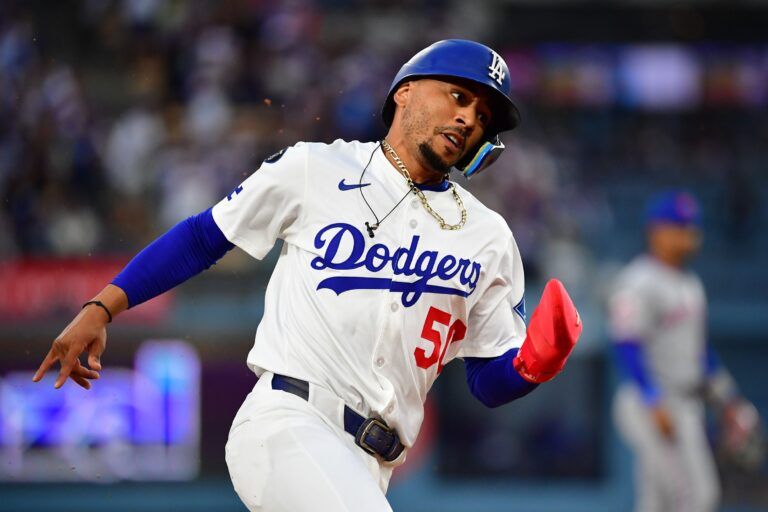 Los Angeles Dodgers shortstop Mookie Betts (50) runs toward home plate to score a run against the New York Mets  during the first inning at Dodger Stadium.