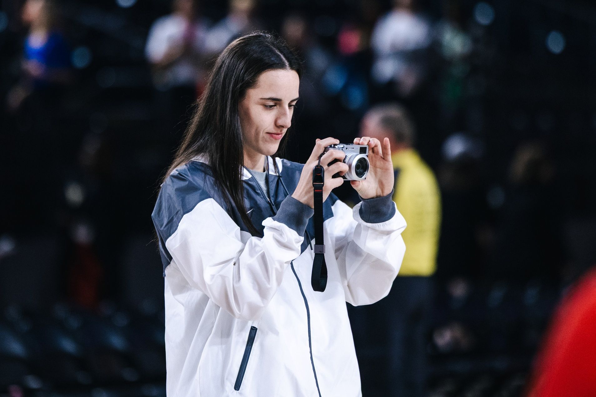 Indiana Fever guard Caitlin Clark takes photos of teammates before the game against the Washington Mystics at Entertainment & Sports Arena.