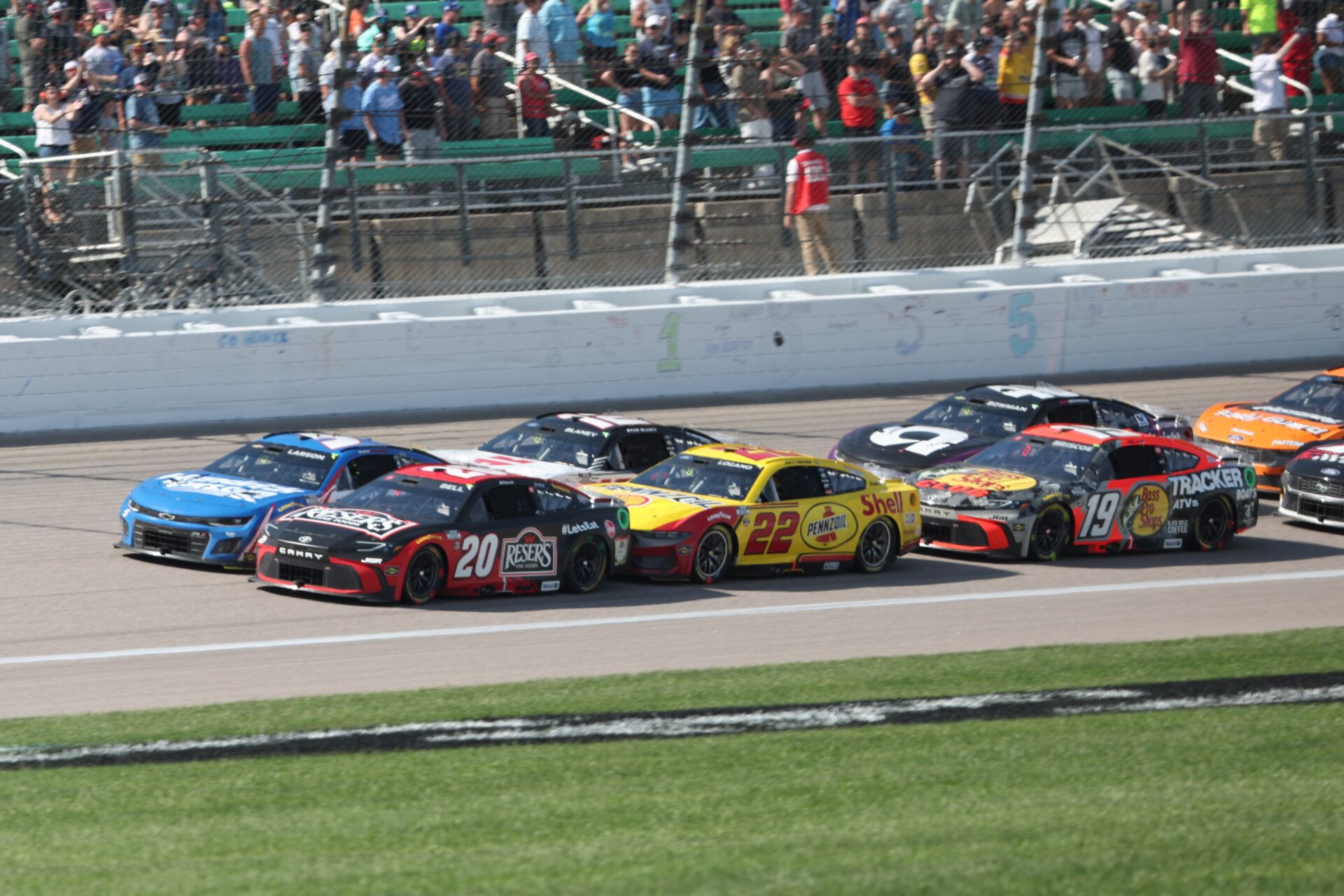 NASCAR Cup Series driver sChristopher Bell (20) and Kyle Larson (5) lead the pack during a restart at the AdventHealth 400 at Kansas Speedway.