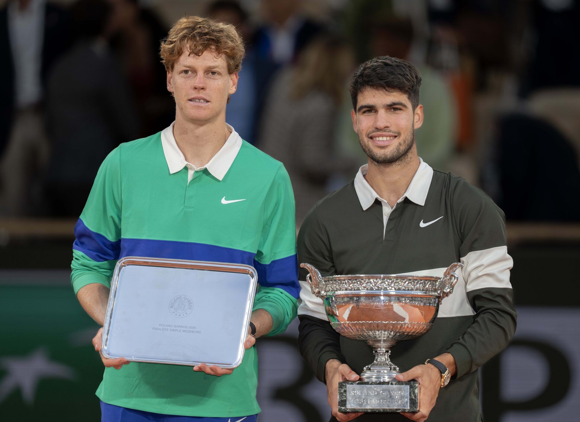 Jannik Sinner of Italy and Carlos Alcaraz of Spain pose together at the trophy presentation after the men’s singles final on day 15 at Roland Garros Stadium.