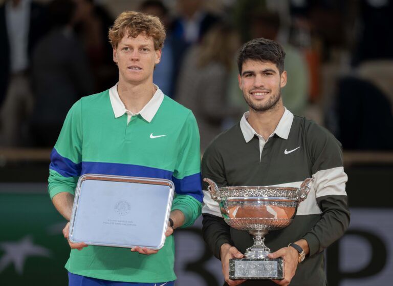 Jannik Sinner of Italy and Carlos Alcaraz of Spain pose together at the trophy presentation after the men’s singles final on day 15 at Roland Garros Stadium.
