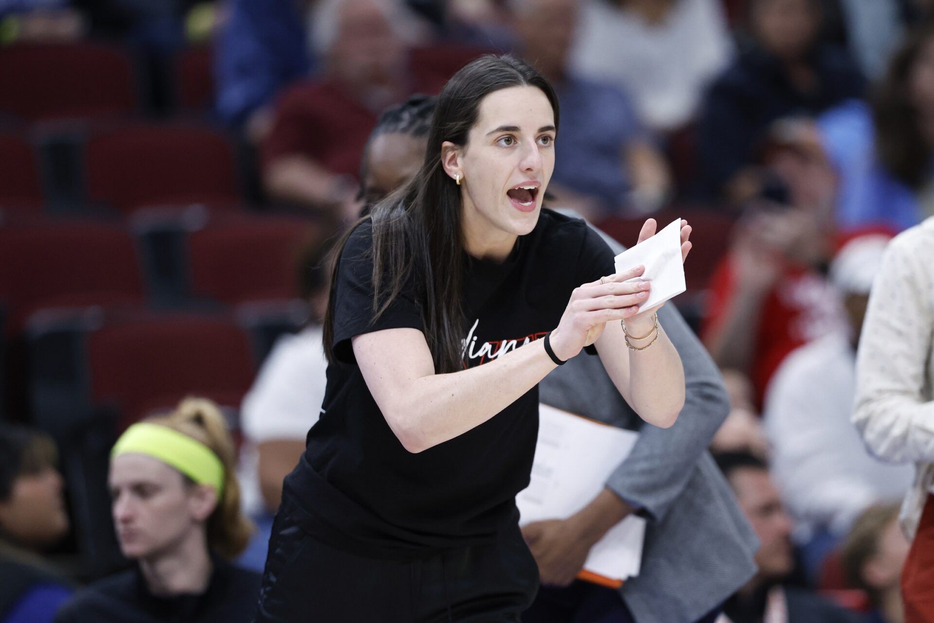 Indiana Fever guard Caitlin Clark (22) applauds her teammates during the first half of a WNBA game against the Chicago Sky at United Center.