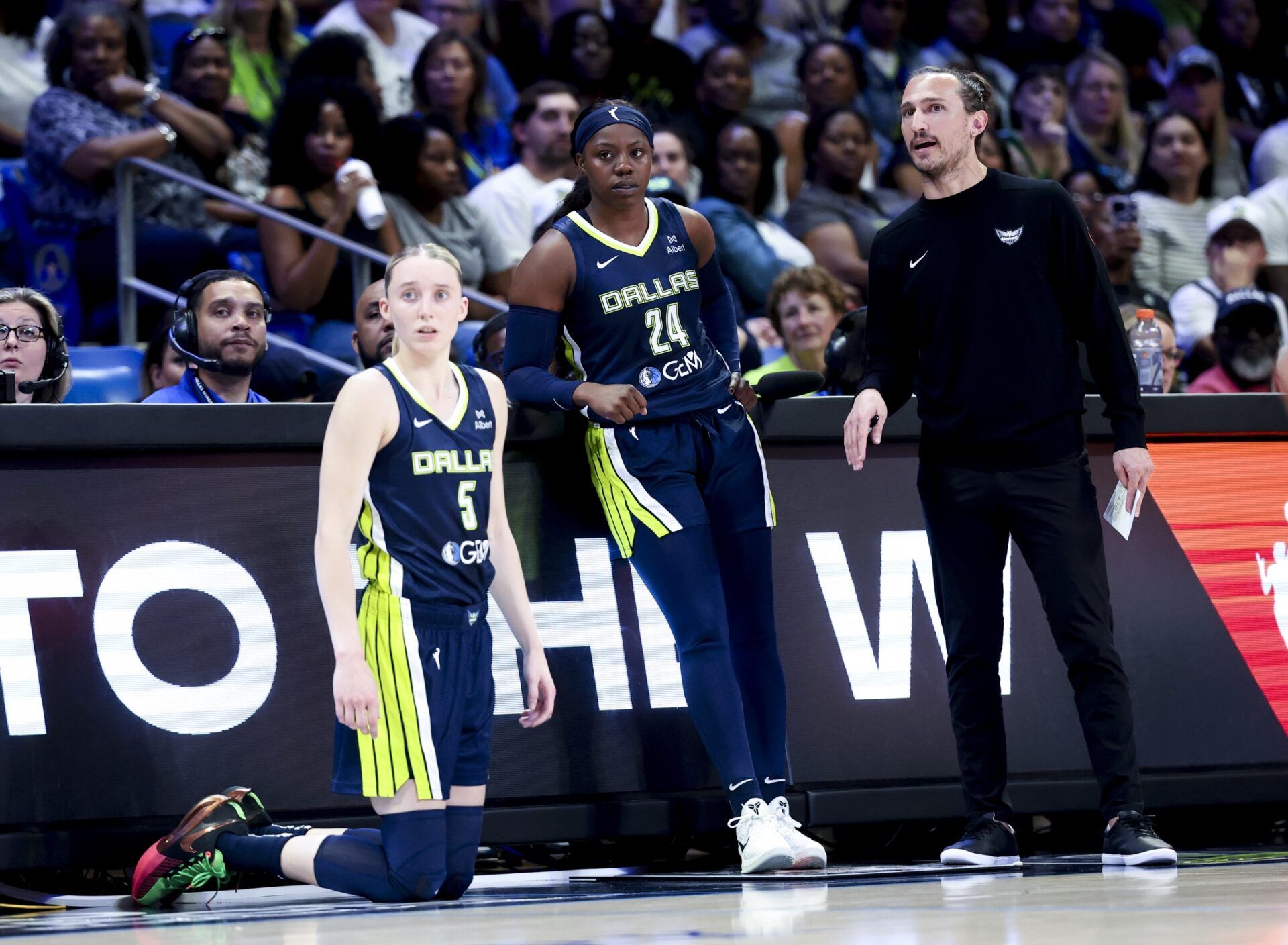 Dallas Wings guard Paige Bueckers (5) and Dallas Wings guard Arike Ogunbowale (24) and Dallas Wings head coach Chris Koclanes talk against the Minnesota Lynx during the first half at College Park Center.