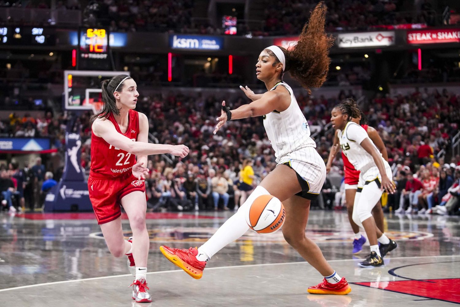 Indiana Fever guard Caitlin Clark (22) passes around Chicago Sky forward Angel Reese (5) on Saturday, May 17, 2025, during a game between the Indiana Fever and the Chicago Sky at Gainbridge Fieldhouse in Indianapolis. The Indiana Fever defeated the Chicago Sky, 93-58.