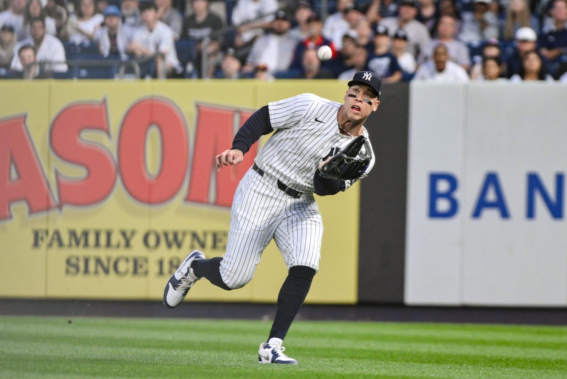 New York Yankees outfielder Aaron Judge (99) catches a fly ball hit by Boston Red Sox outfielder Rob Refsnyder (not pictured) during the fourth inning at Yankee Stadium.