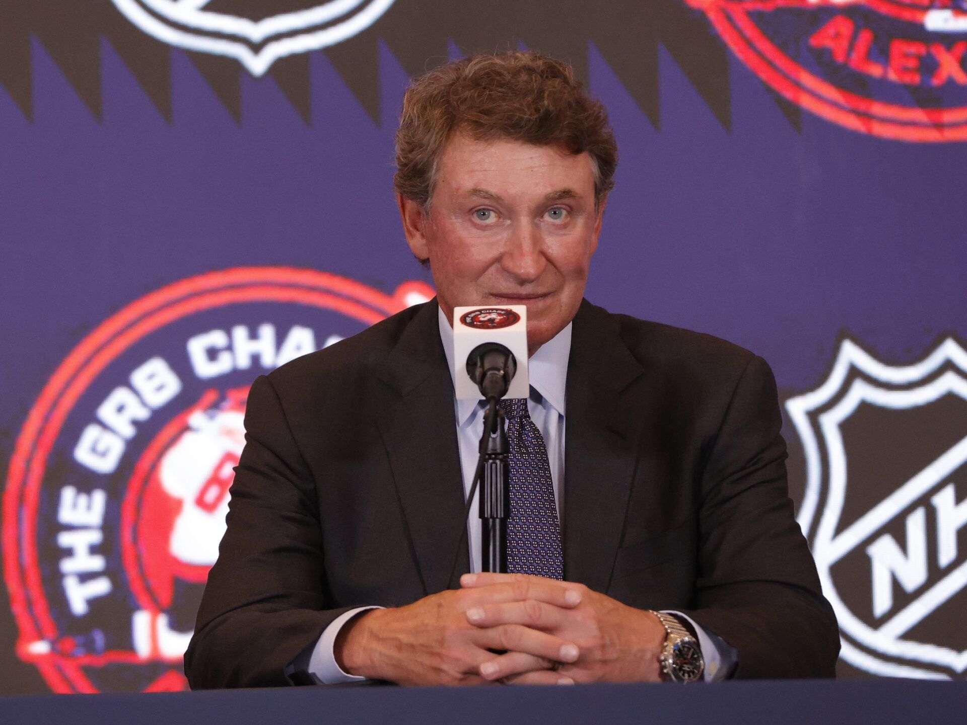 Wayne Gretzky speaks during a press conference with Washington Capitals left wing Alex Ovechkin (not pictured) after the game against the Chicago Blackhawks at Capital One Arena. Ovechkin scored the 893rd and 894th goals of his career, tying Gretzky for most all-time goals in NHL history at Capital One Arena.