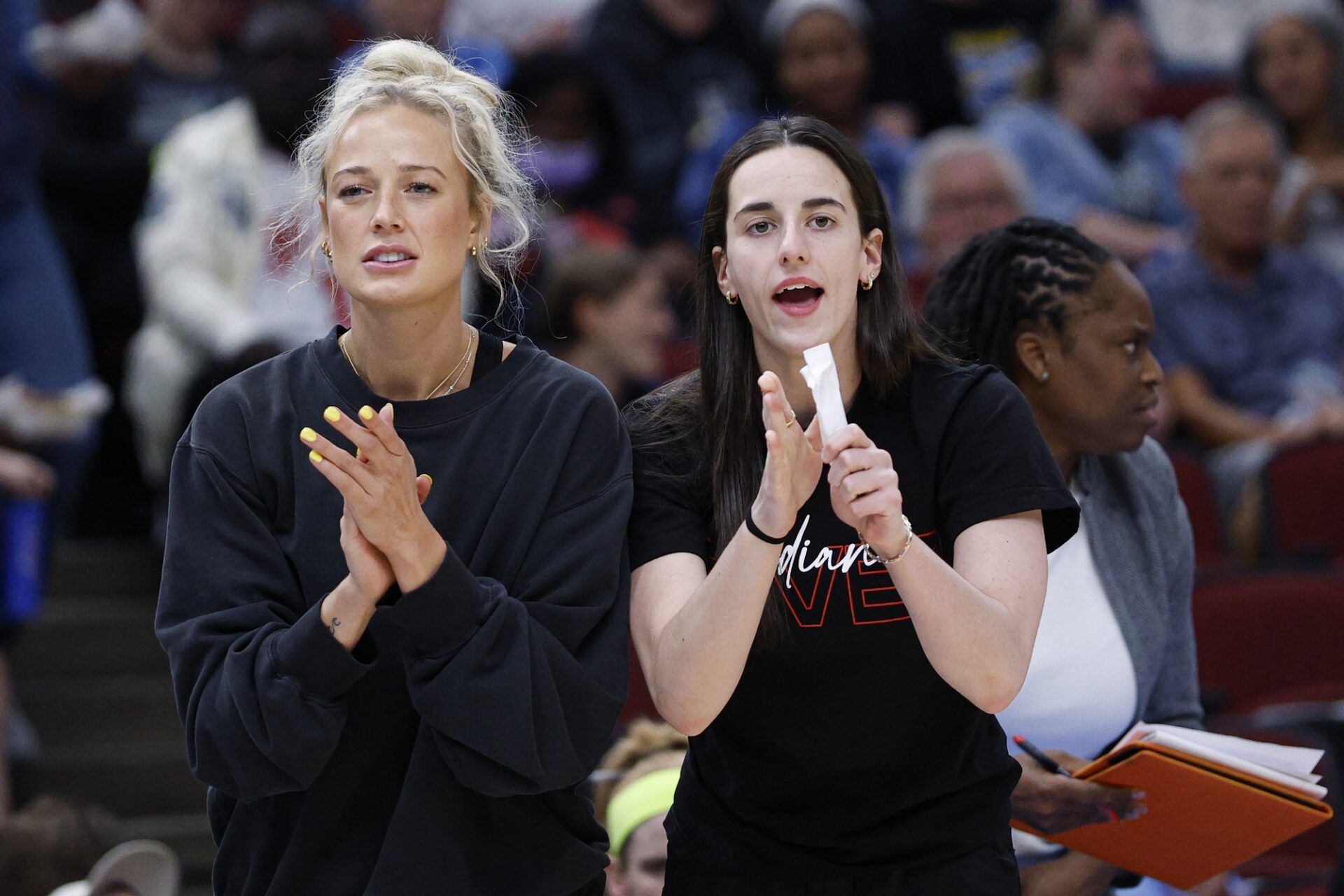 Injured Indiana Fever guard Sophie Cunningham (8) and guard Caitlin Clark (22) react from the bench during the first half of a WNBA game against the Chicago Sky at United Center.
