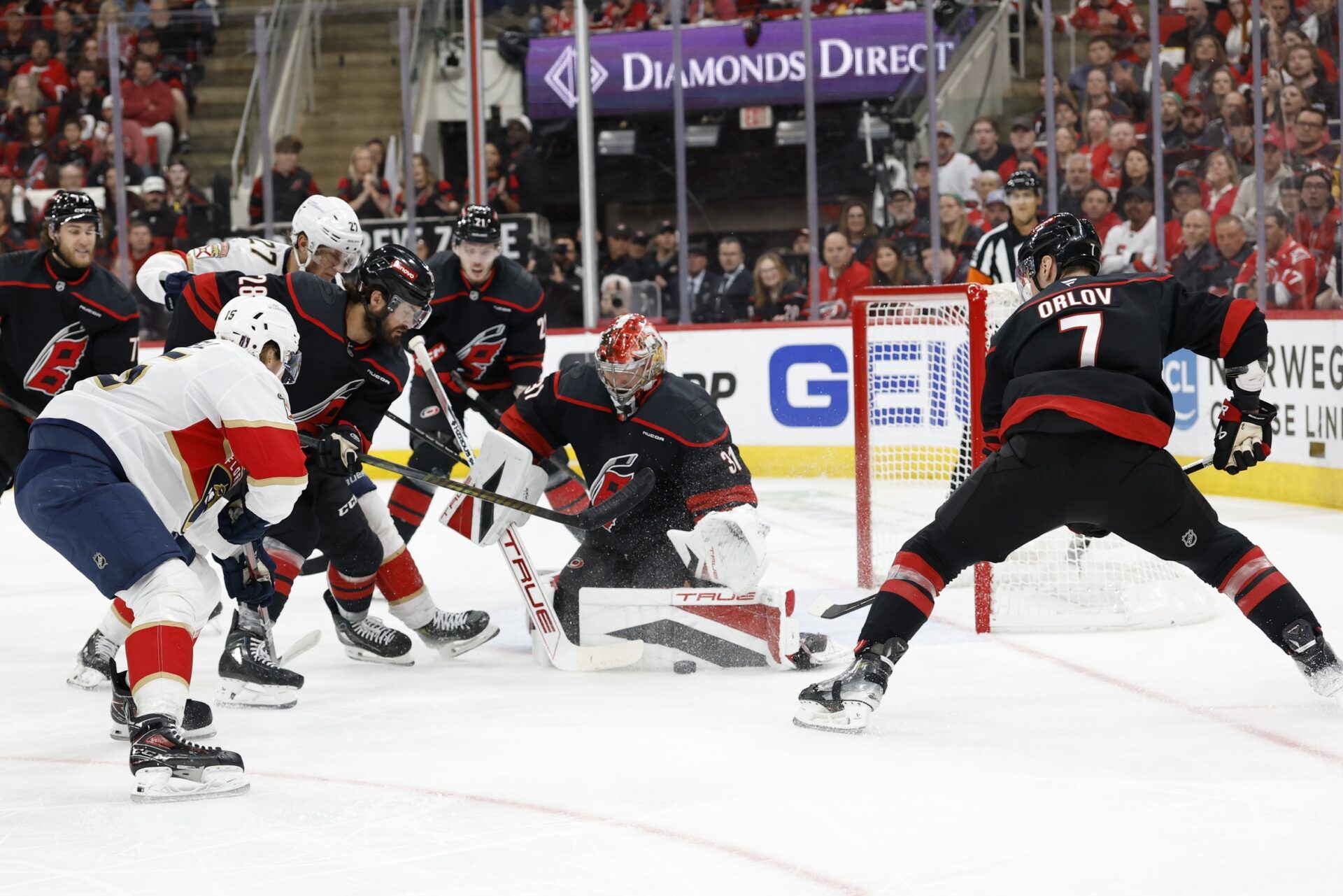 Carolina Hurricanes goaltender Frederik Andersen (31) blocks a sh0ot by Florida Panthers forward Anton Lundell (15) as Carolina Hurricanes defenseman Dmitry Orlov (7) defends  during the first period n game five of the Eastern Conference Final of the 2025 Stanley Cup Playoffs at Lenovo Center.