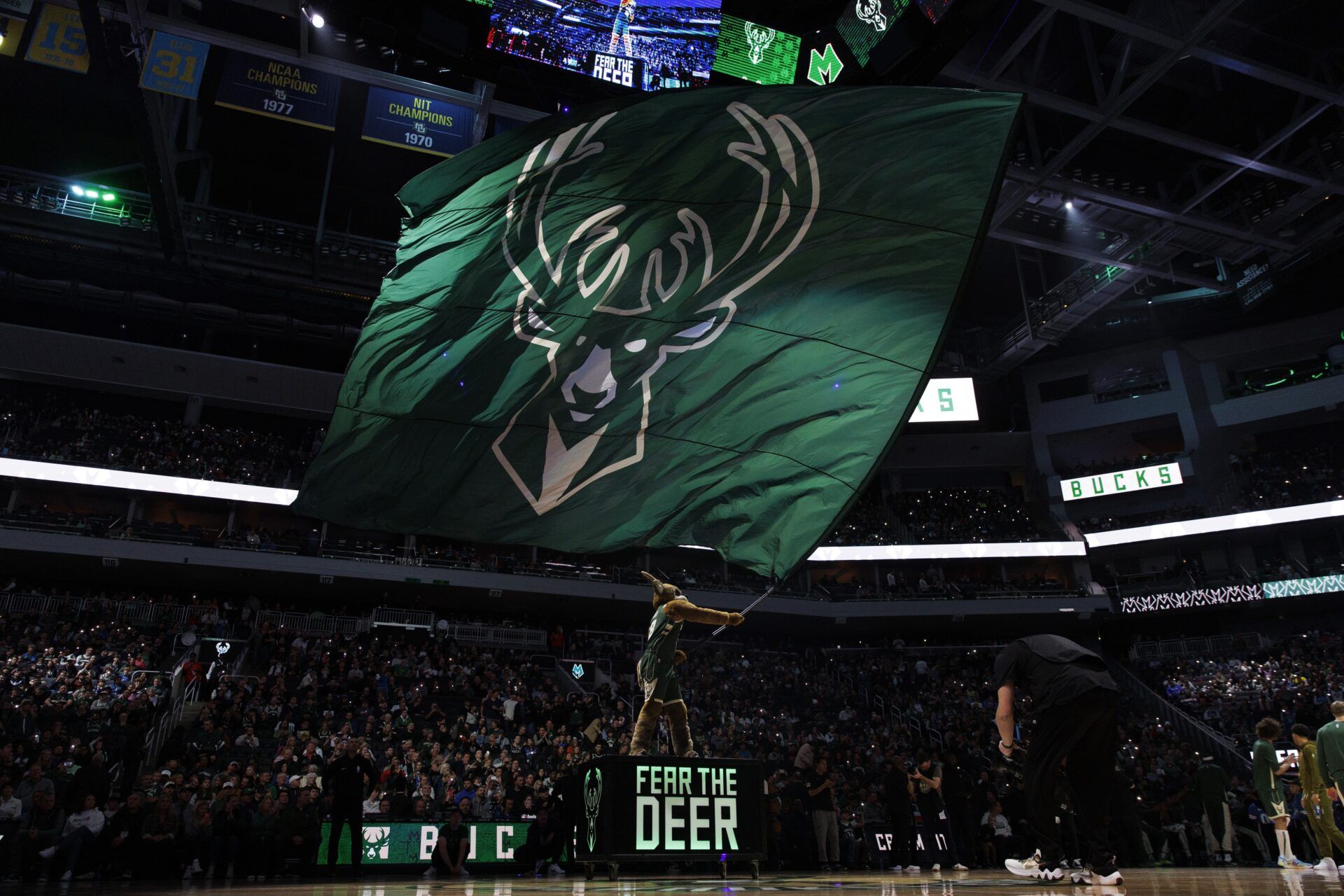 Milwaukee Bucks mascot Bango waves a flag with the Milwaukee Bucks logo prior to the game against the Portland Trail Blazers at Fiserv Forum.
