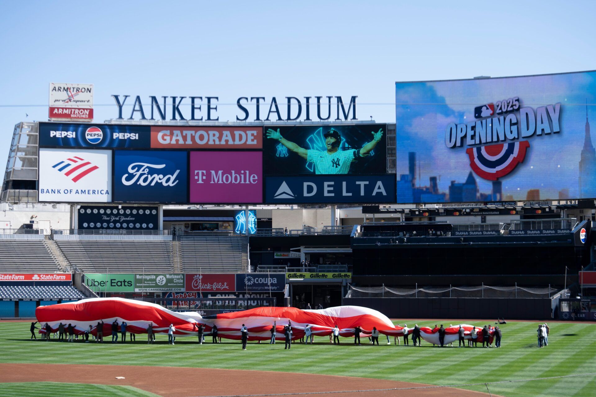 People practice unveiling the American flag prior to the start of the opening day game between the NY Yankees and Milwaukee Brewers at Yankee Stadium on Thursday, March 27, 2025.