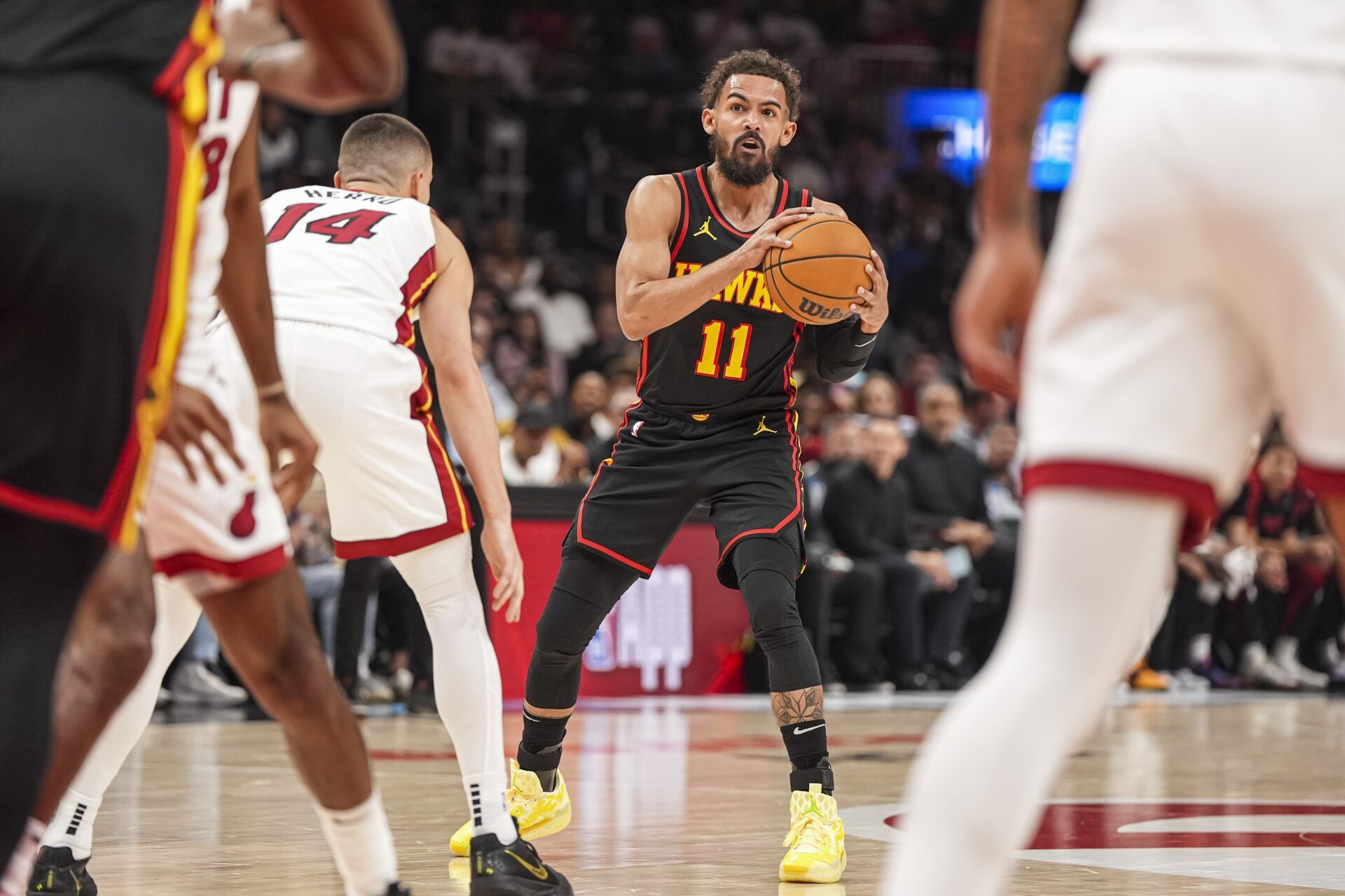 Atlanta Hawks guard Trae Young (11) controls the ball against Miami Heat guard Tyler Herro (14) during the first half at State Farm Arena.