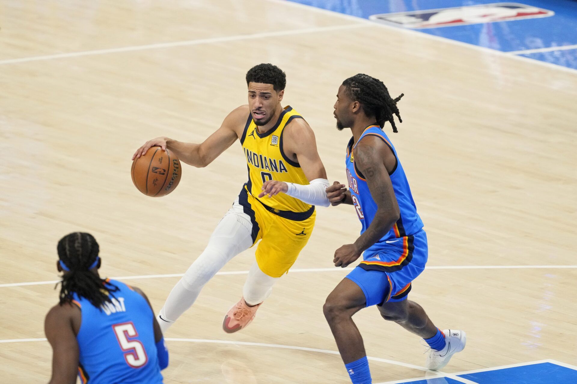 Indiana Pacers guard Tyrese Haliburton (0) dribbles the ball against Oklahoma City Thunder guard Cason Wallace (22) during the first quarter during game two of the 2025 NBA Finals at Paycom Center.